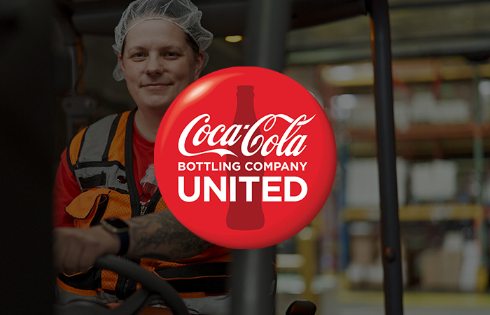 Coca Coca Bottling Company United Logo with employee in background
